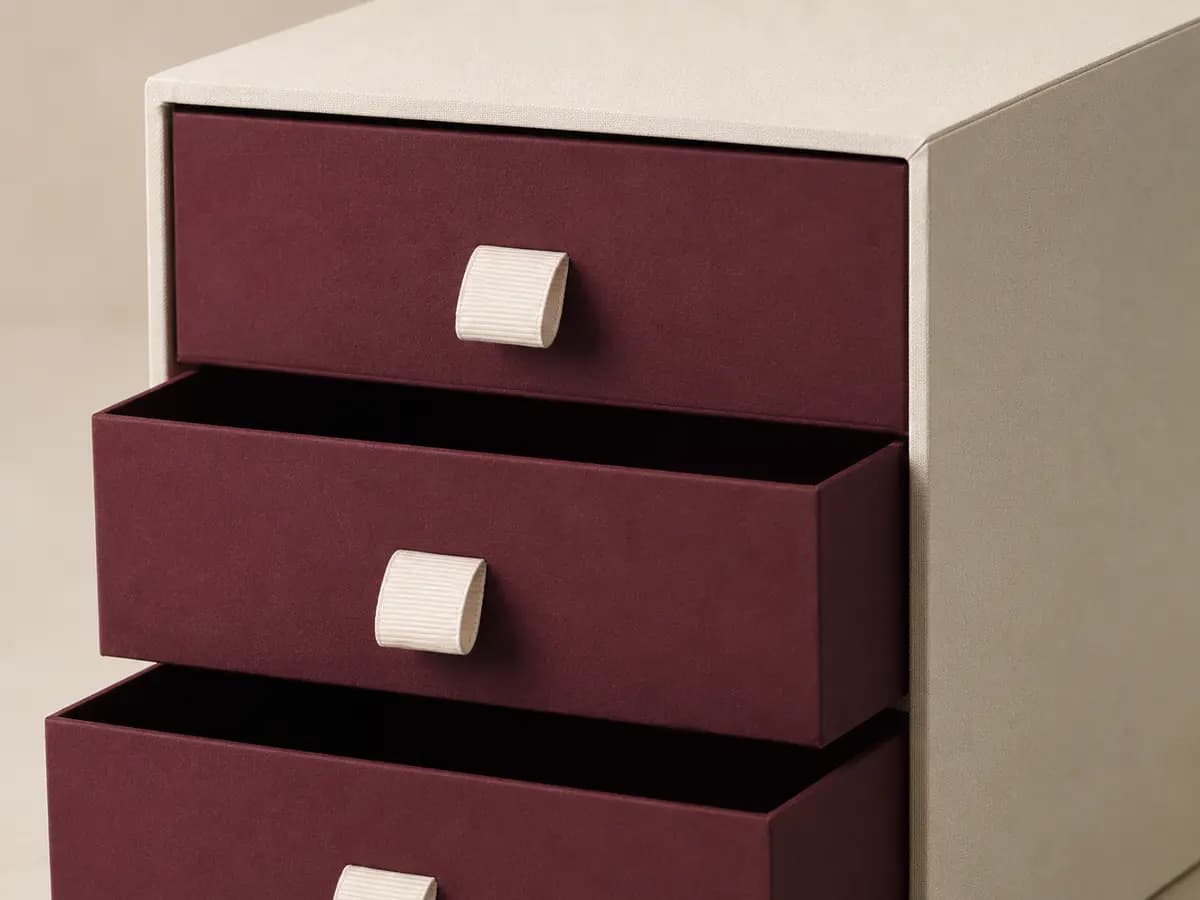 Close-up of wrapped corners and ribbon pulls on a multi-tier drawer box