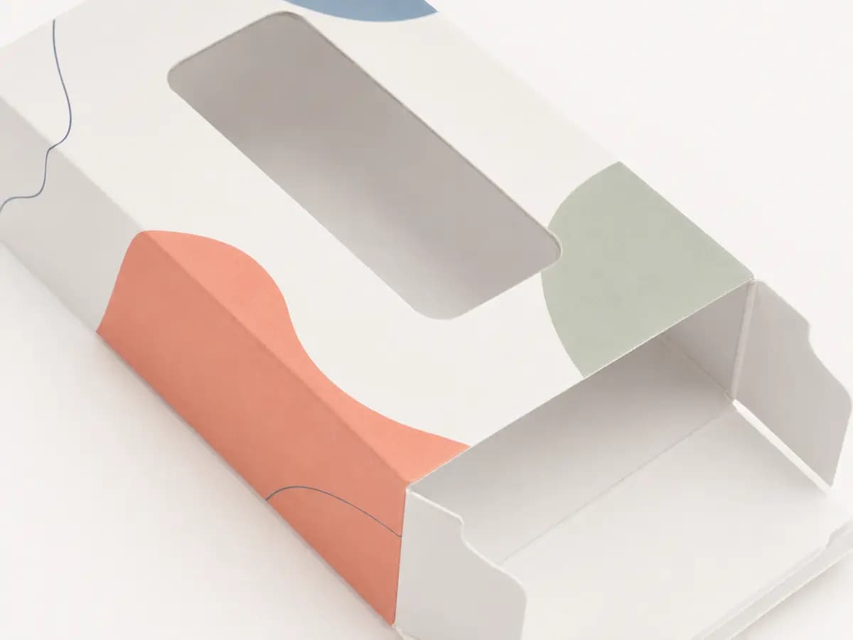 White paperboard window tuck carton showing die-cut opening and folded locking tabs